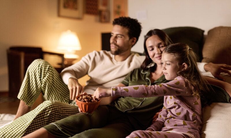 Family On Couch Eating walnuts
