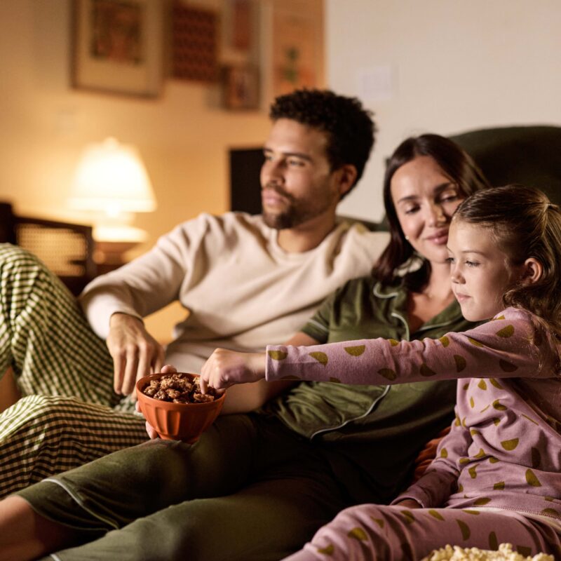 Family On Couch Eating walnuts