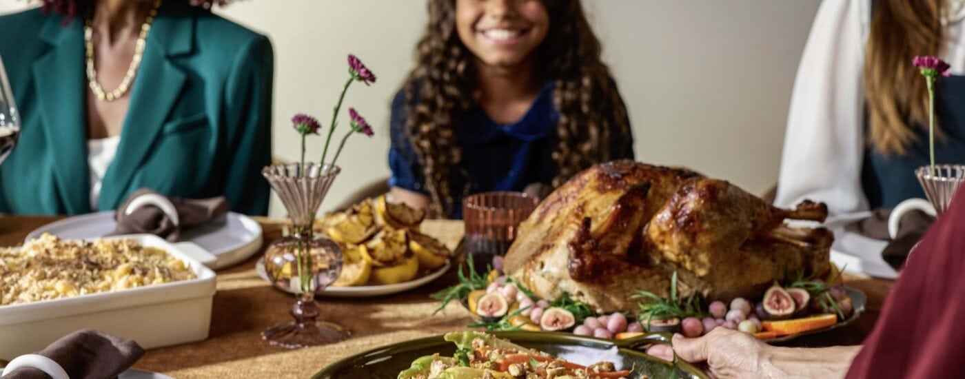 family around a table with a holiday meal