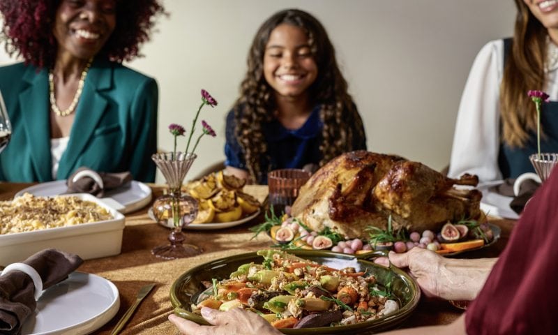 family around a table with a holiday meal