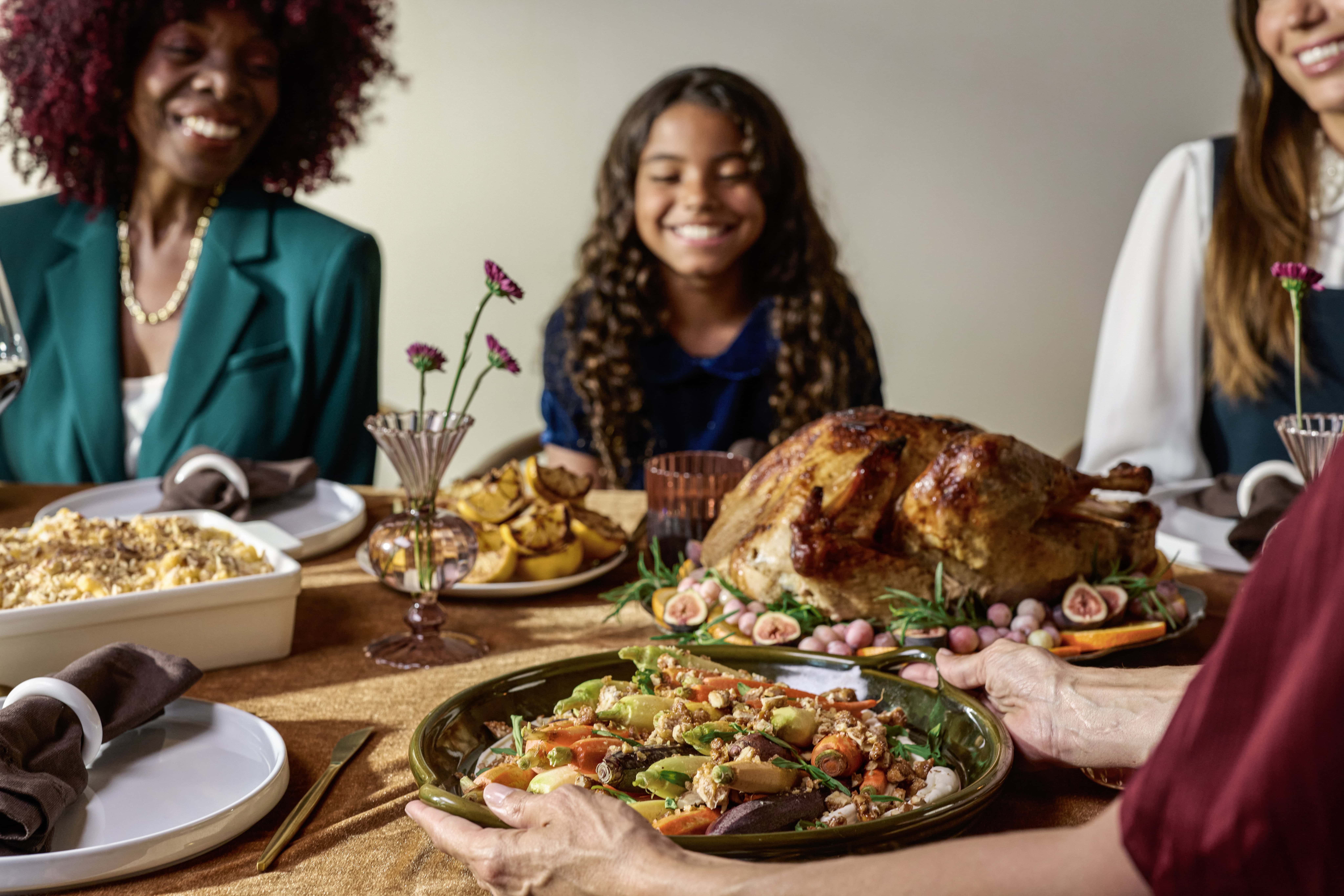 family around a table with a holiday meal